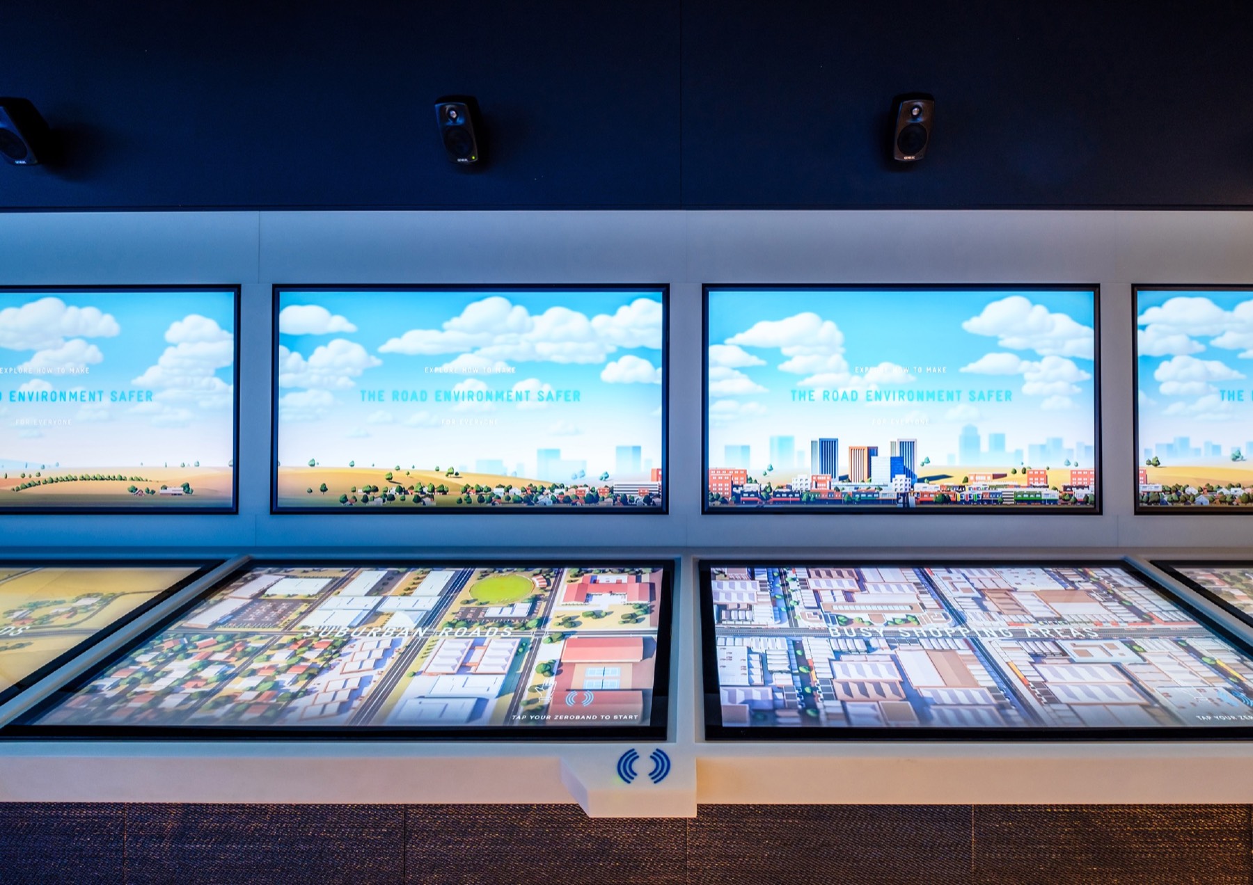 Safer Systems touch tables beneath a row of screens