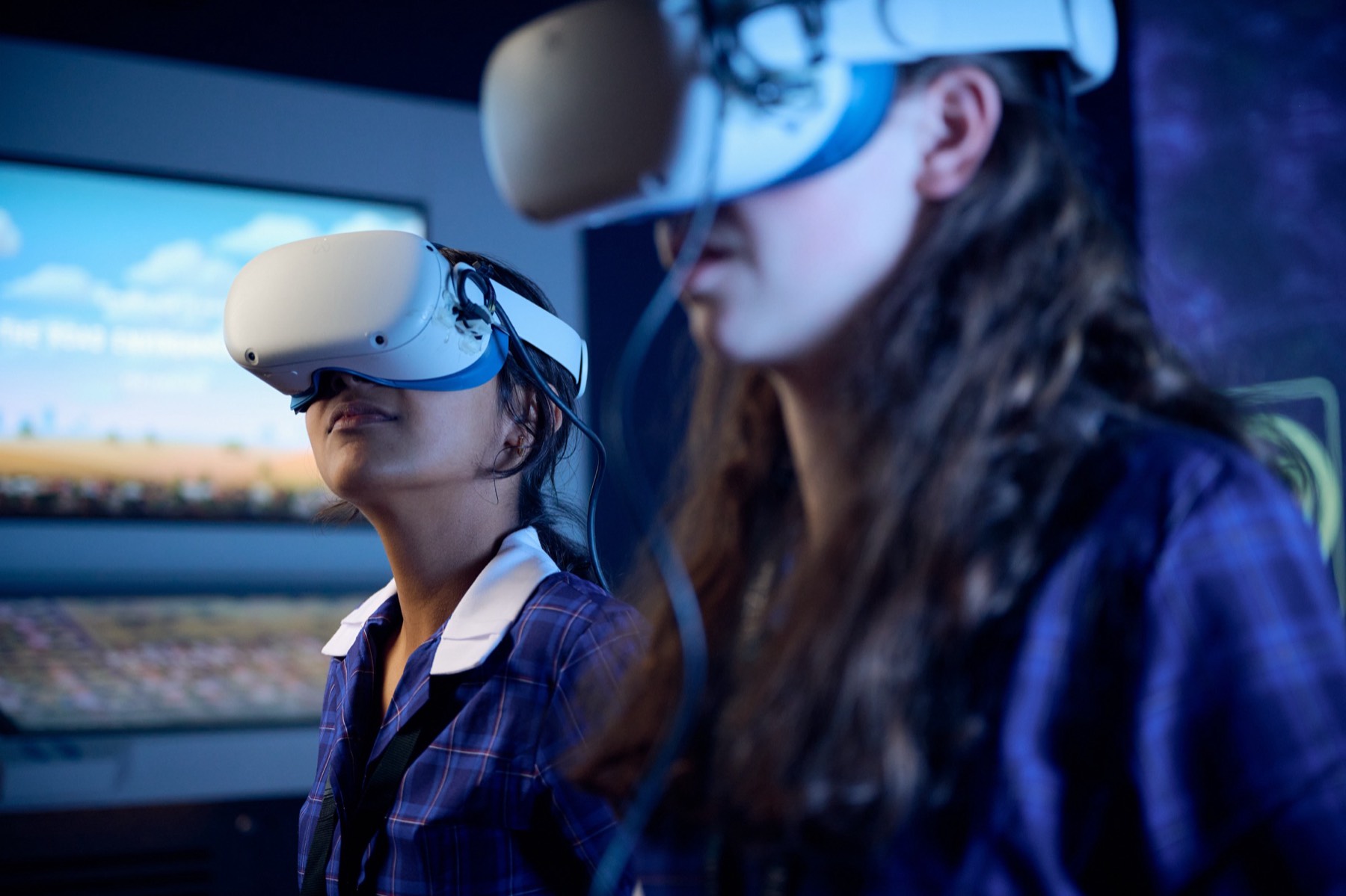 Two students in VR headsets in the exhibition